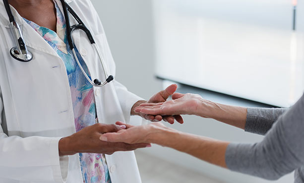 doctor checking patient muscular function in hands